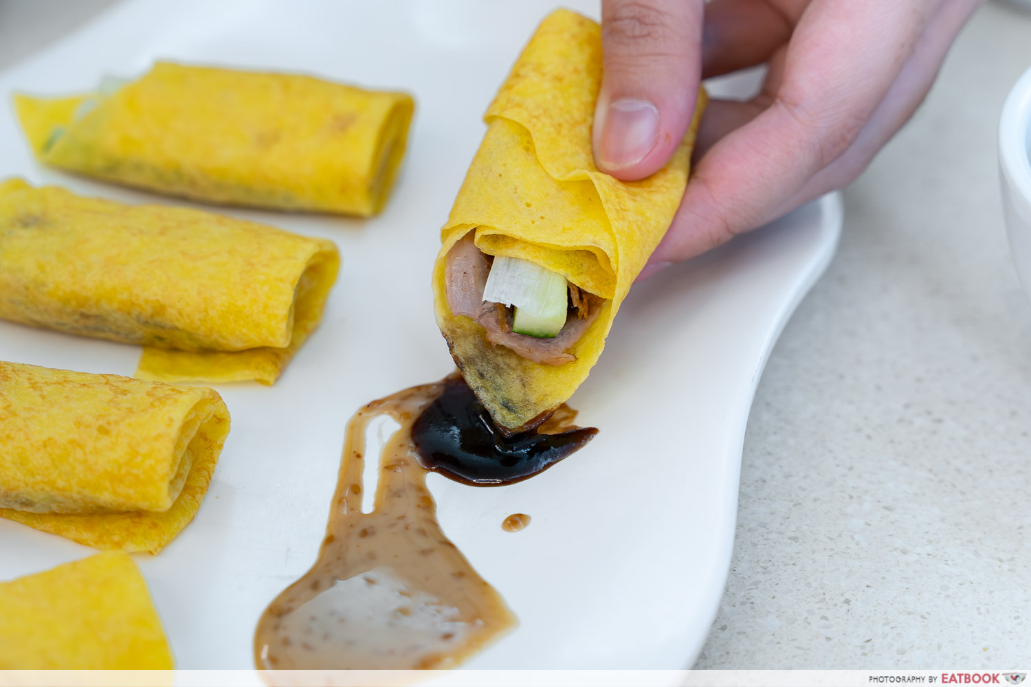the-dim-sum-place-peking-duck-wrap-dipping-interaction