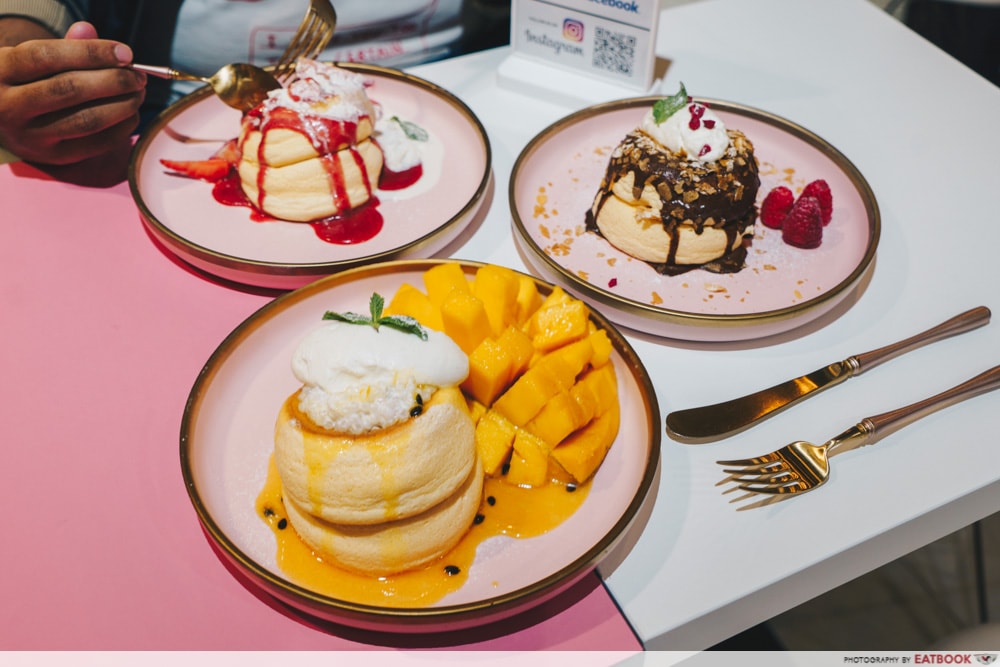 Three plates of souffle pancakes on a table