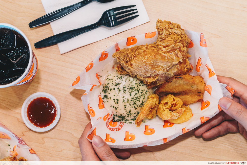 Hands reaching out to the Cajun Surf n Turf combo 