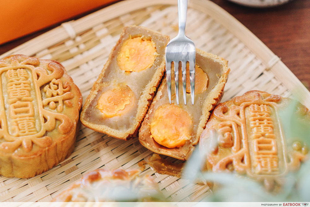 Fork piercing through the double yolk mooncake 