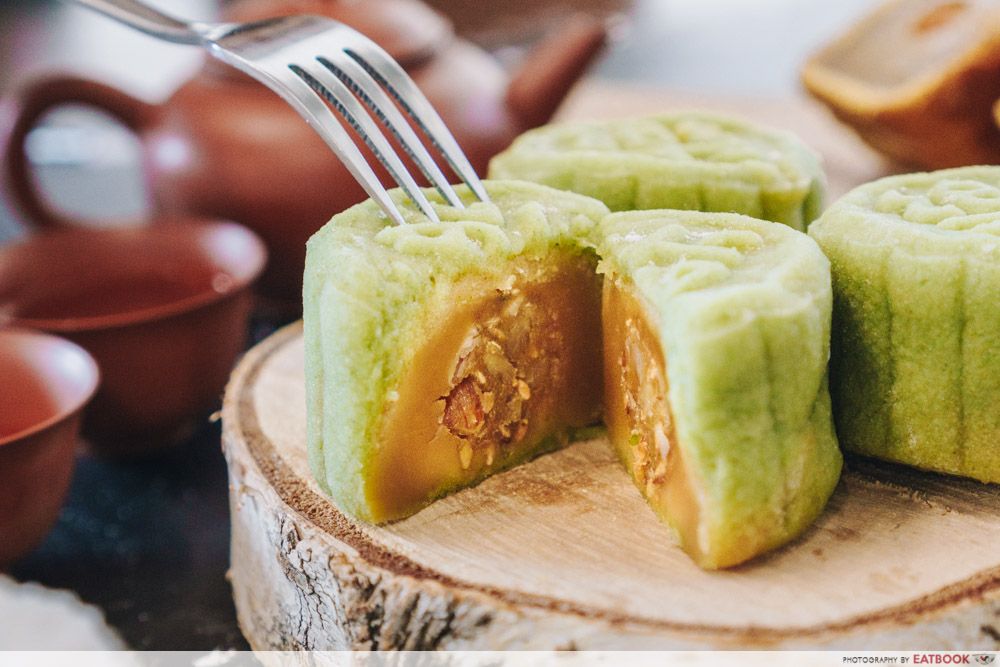 Inside of green snowskin mooncake; lotus paste filling