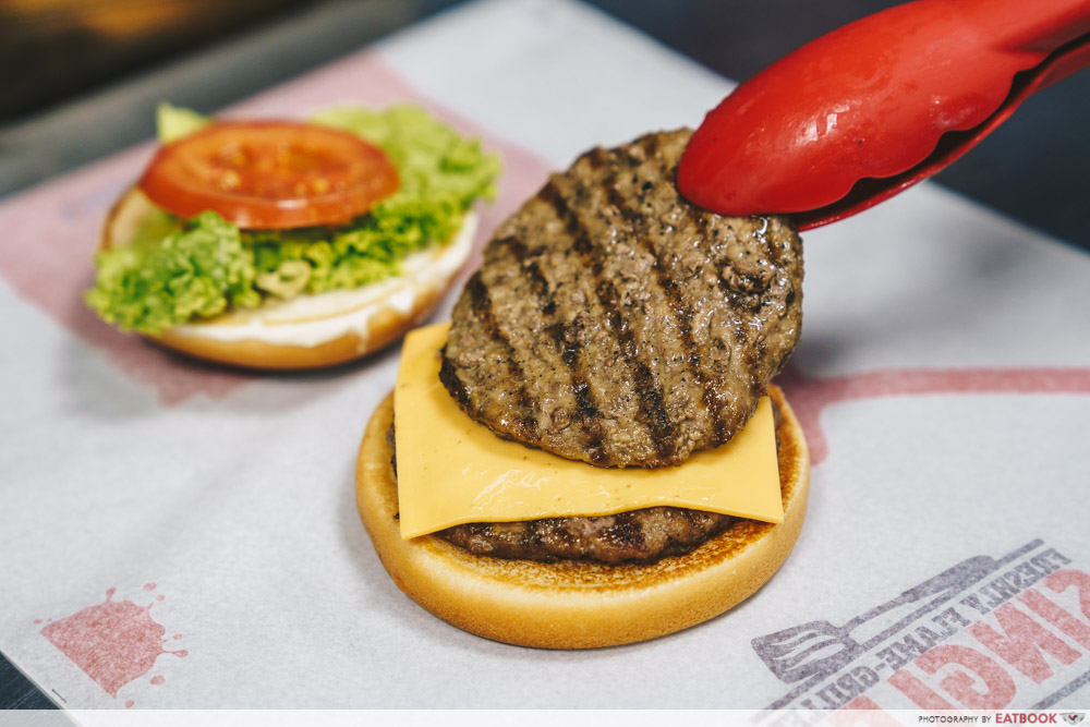 Placing a patty on a burger