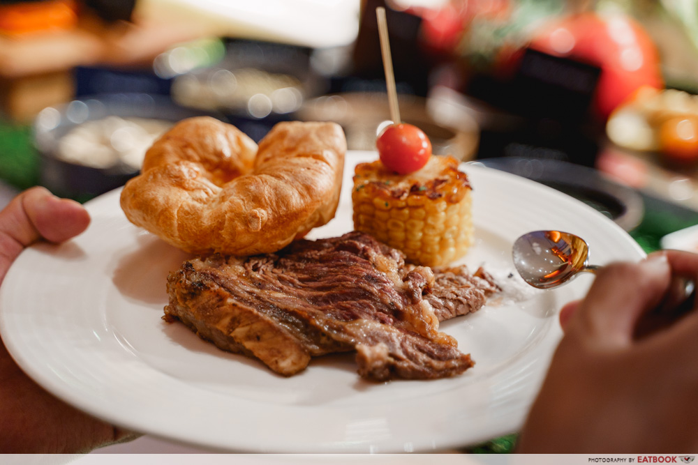 A plate of beef, pudding and corn