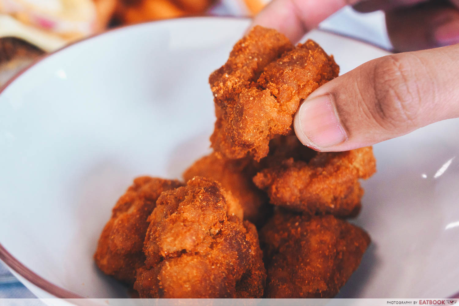 Finger holding chicken