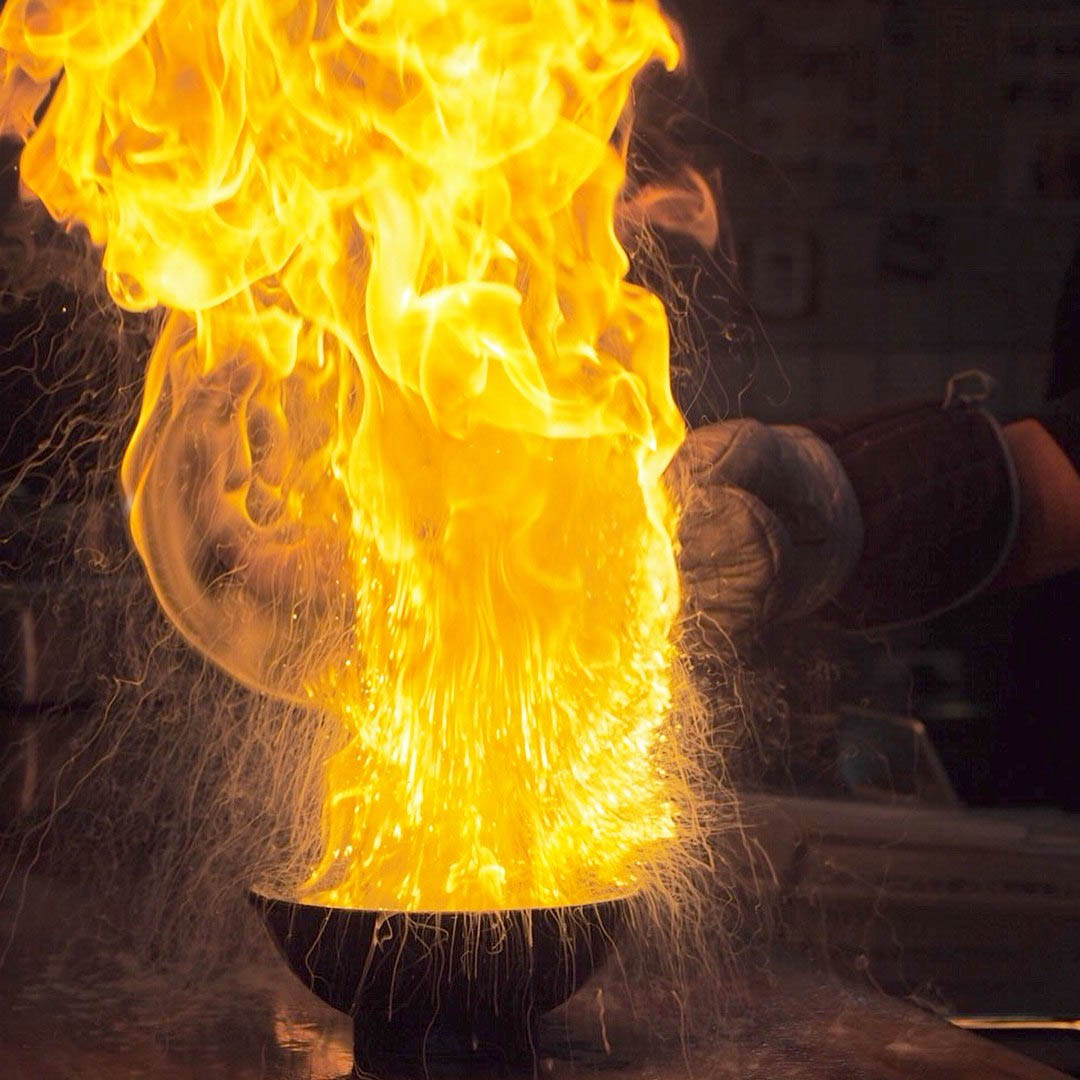 Menbaka Fire Ramen - Close-up shot of flaming ramen bowl