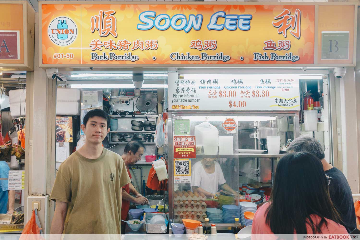 Soon Lee Porridge - Storefront shot with owner