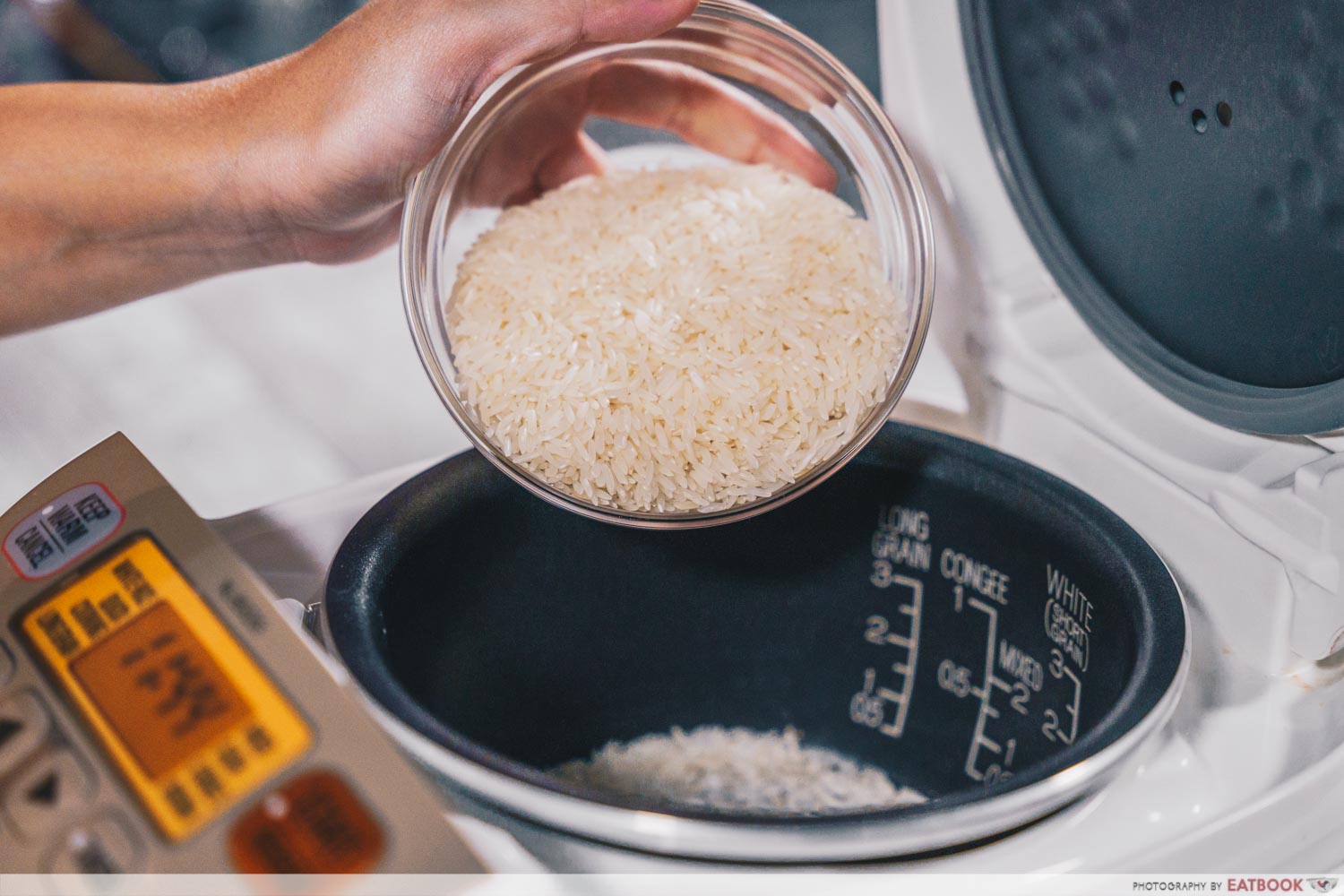 putting rice into a rice cooker