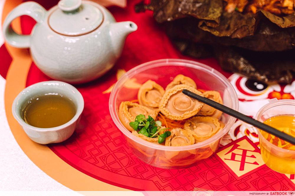 abalone yusheng picked up with chopsticks