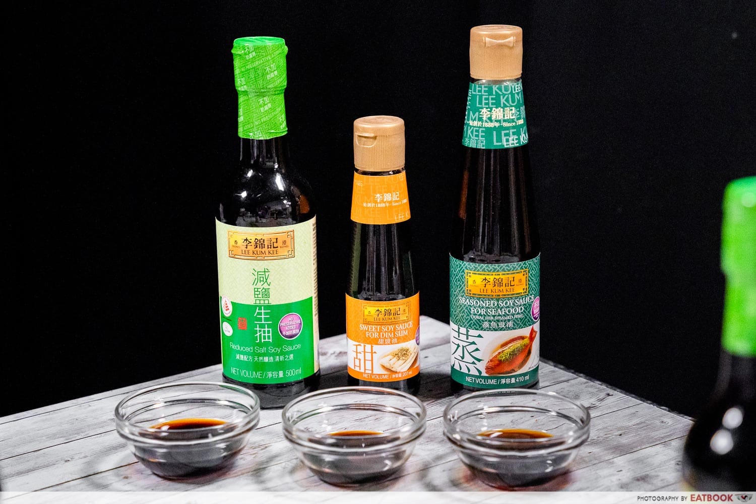 three bottles of lee kum kee sauces 