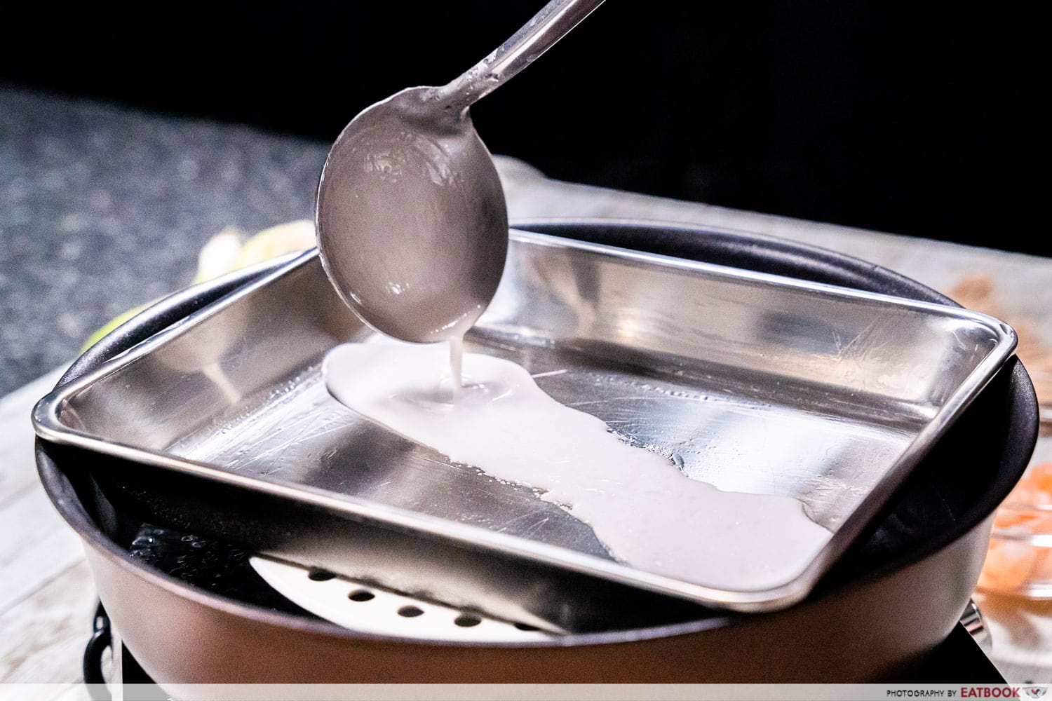 pouring the chee cheong fan mixture 