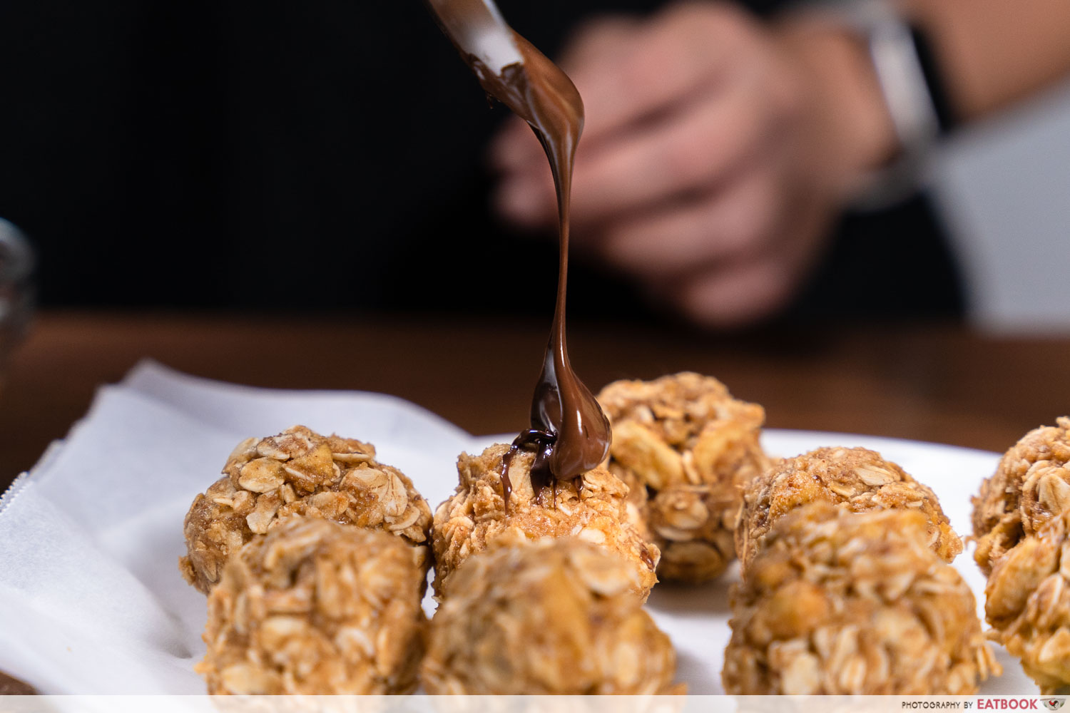 plucked freeze-dried fruit recipes - drizzling chocolate on no-bake peanut butter balls