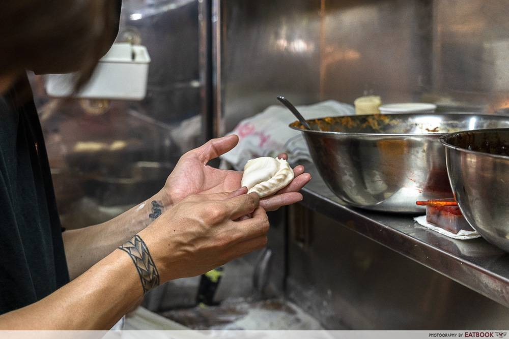 wang wang crispy curry puff hand wrapping