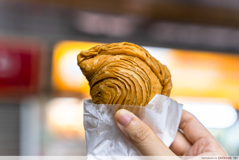 wang wang crispy curry puff in hand