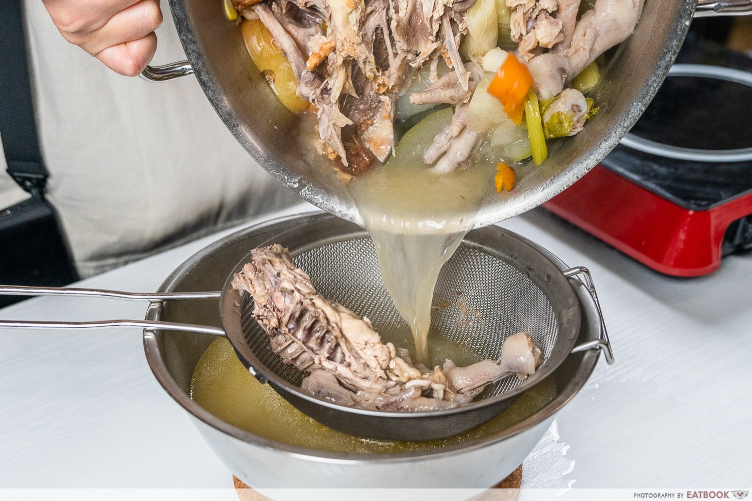easy hotpot broth recipe - straining chicken stock