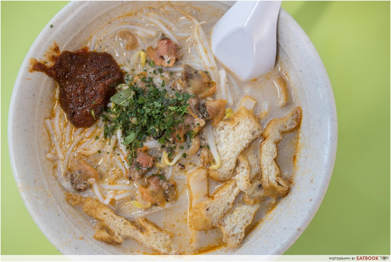 famous sungei road laksa flatlay storefront asia's delight laksa close up